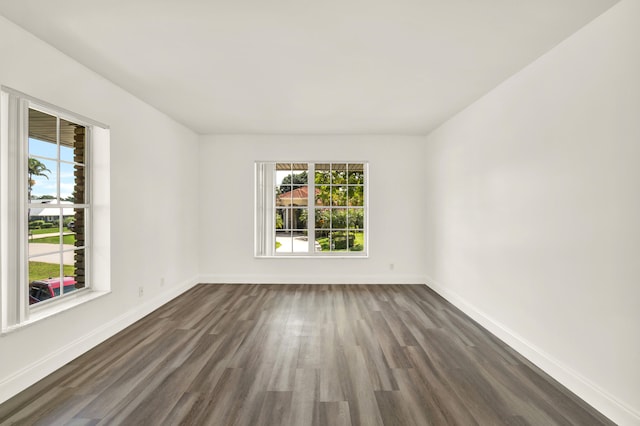 unfurnished room featuring dark wood-type flooring