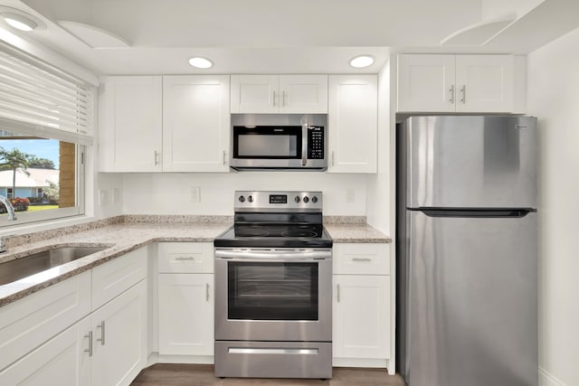 kitchen featuring appliances with stainless steel finishes and white cabinetry