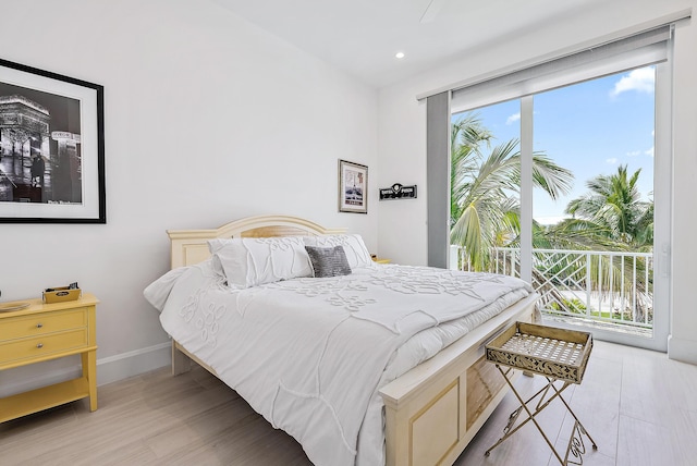 bedroom with baseboards, light wood-style floors, recessed lighting, and access to exterior