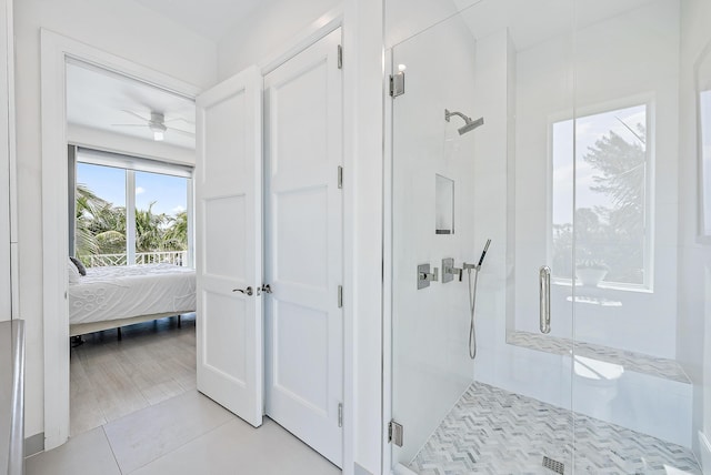 bathroom with tile patterned floors, ensuite bath, a ceiling fan, and a shower stall