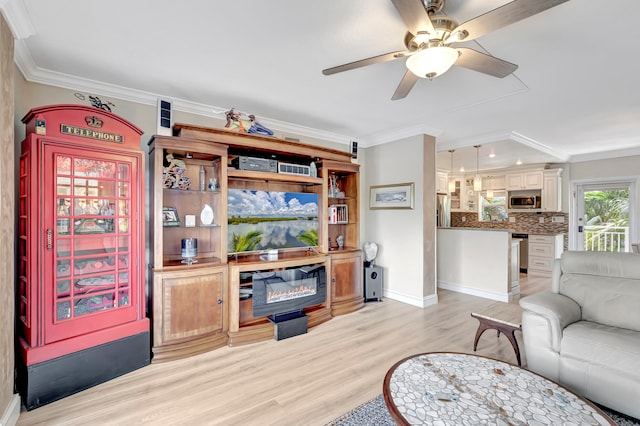 living room with crown molding, ceiling fan, and light hardwood / wood-style flooring