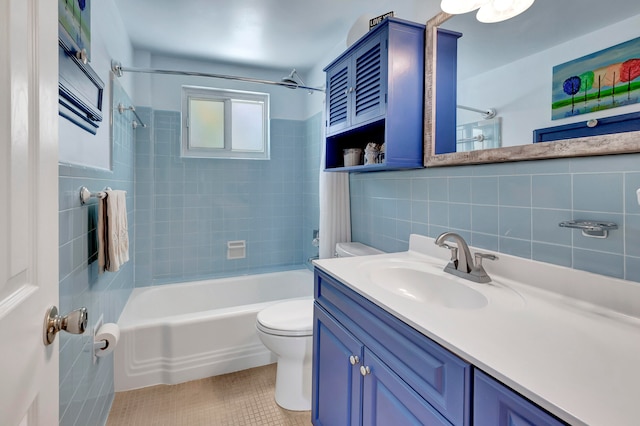 full bathroom featuring backsplash, tile walls, tiled shower / bath, vanity with extensive cabinet space, and toilet