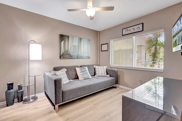 living room featuring light hardwood / wood-style floors and ceiling fan