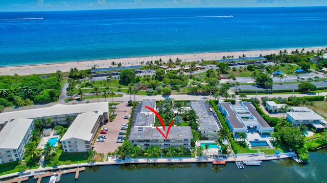 drone / aerial view with a beach view and a water view