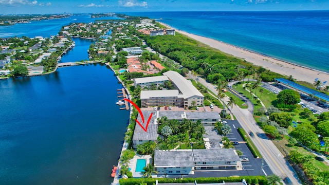 drone / aerial view featuring a beach view and a water view