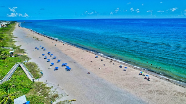 aerial view with a water view and a view of the beach