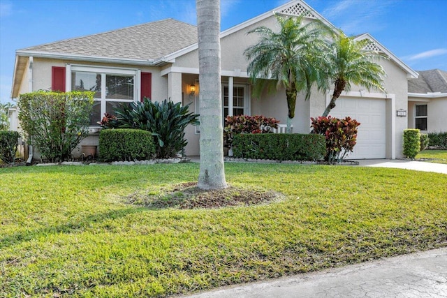 view of front of home with a front lawn and a garage