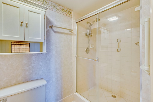 bathroom featuring walk in shower and toilet