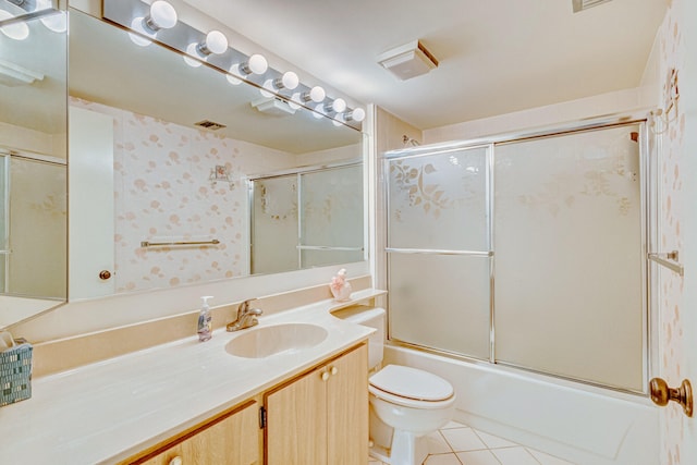 full bathroom with tile flooring, vanity, toilet, and shower / bath combination with glass door