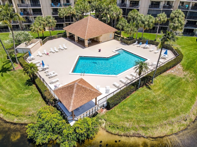 view of swimming pool featuring a patio and a lawn