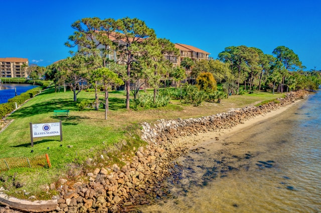 view of nearby features with a water view and a lawn