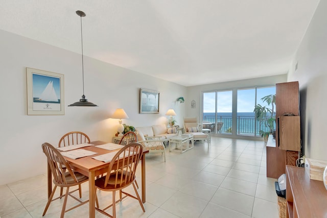 tiled dining room featuring a water view