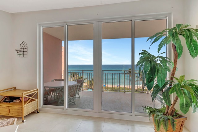 entryway featuring light tile flooring and a water view