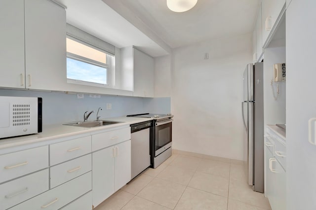 kitchen featuring stainless steel fridge, dishwashing machine, light tile flooring, sink, and white cabinets