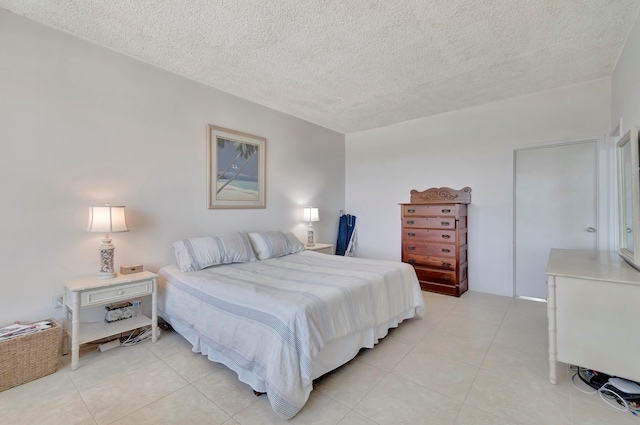 tiled bedroom featuring a textured ceiling