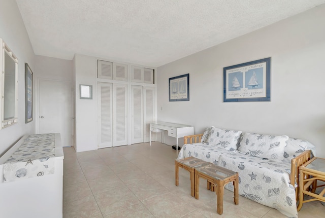 tiled living room featuring a textured ceiling