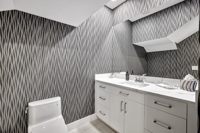 bathroom with vaulted ceiling, vanity, and toilet