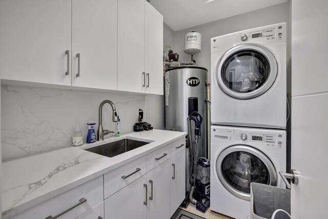 laundry room with electric water heater, sink, and stacked washer and clothes dryer