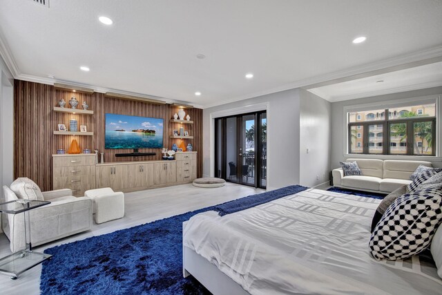 bedroom featuring multiple windows, hardwood / wood-style floors, and crown molding