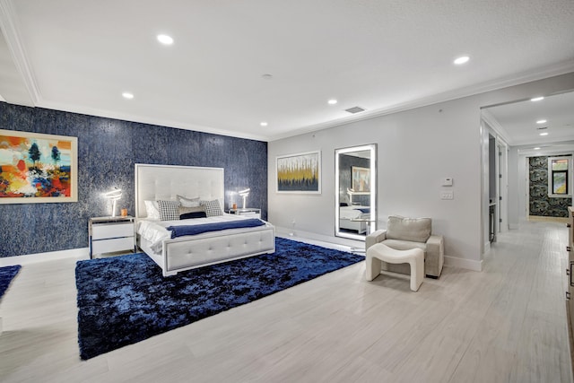 bedroom with ornamental molding and light hardwood / wood-style floors