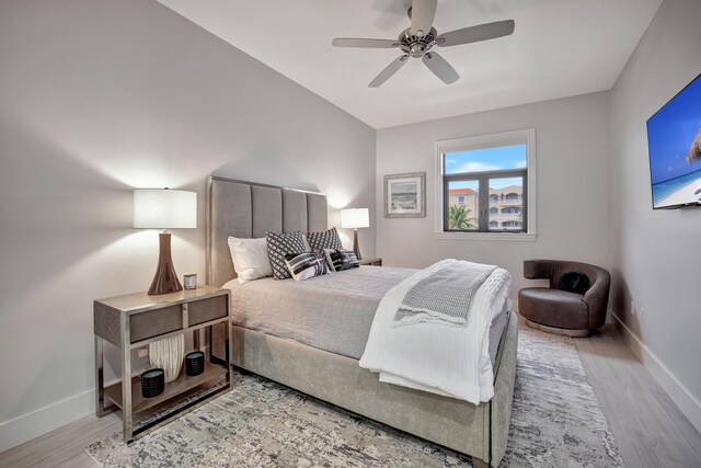 bedroom with ceiling fan and light hardwood / wood-style floors