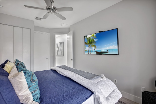 bedroom featuring wood-type flooring, ceiling fan, and a closet