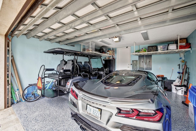 garage with a garage door opener and electric panel