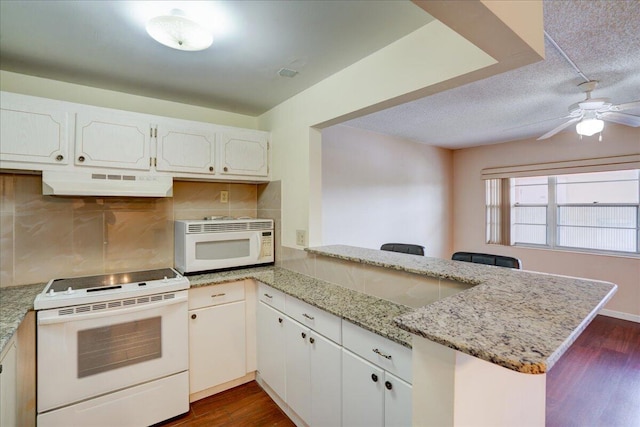 kitchen featuring backsplash, white appliances, white cabinetry, kitchen peninsula, and dark wood-type flooring