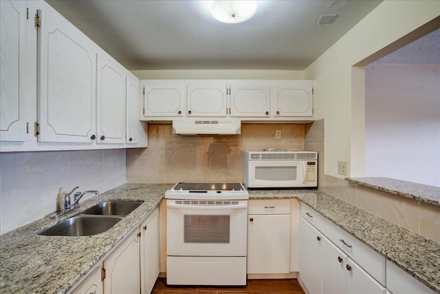 kitchen with light stone counters, sink, white appliances, and white cabinets