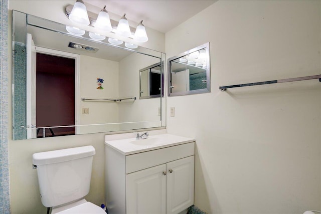 bathroom with toilet and vanity