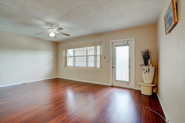 interior space with a textured ceiling, ceiling fan, and hardwood / wood-style floors