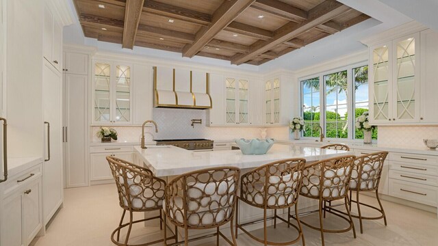 kitchen featuring french doors, a kitchen island, white cabinets, a chandelier, and decorative light fixtures