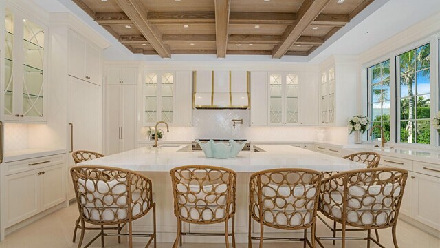 tiled spare room with french doors, coffered ceiling, a chandelier, and a wealth of natural light