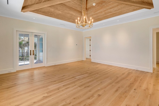 empty room featuring a chandelier, light wood-type flooring, wooden ceiling, and french doors