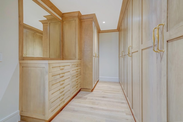 hall featuring ornamental molding and light wood-type flooring