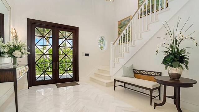 empty room featuring coffered ceiling, a chandelier, wooden ceiling, french doors, and beamed ceiling