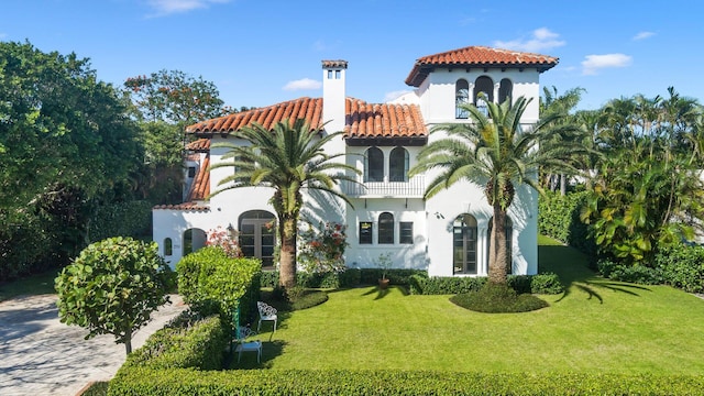 mediterranean / spanish house with a front yard