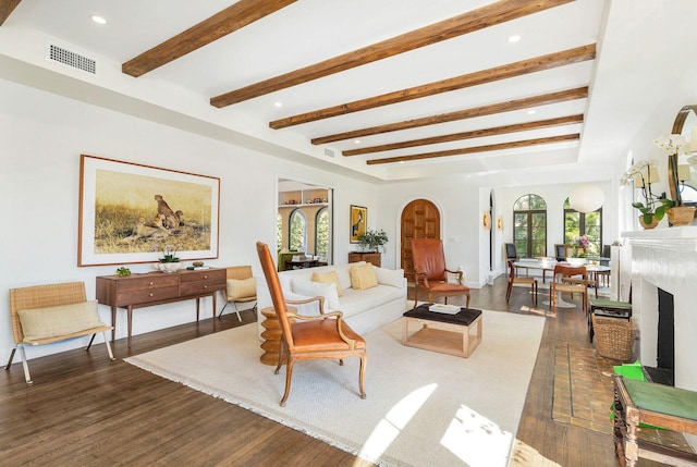 living room with dark hardwood / wood-style floors and beam ceiling