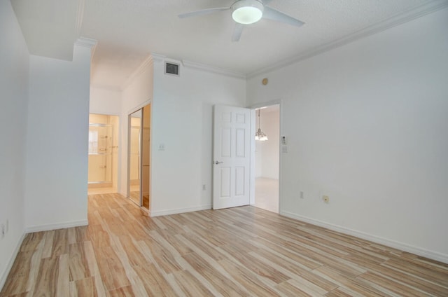 interior space featuring ornamental molding, ceiling fan, and light hardwood / wood-style flooring