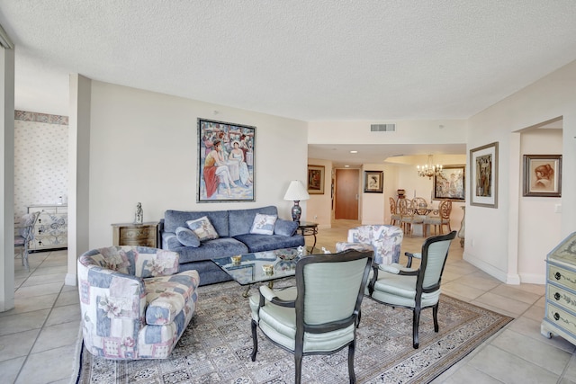 living room featuring light tile floors, a textured ceiling, and an inviting chandelier