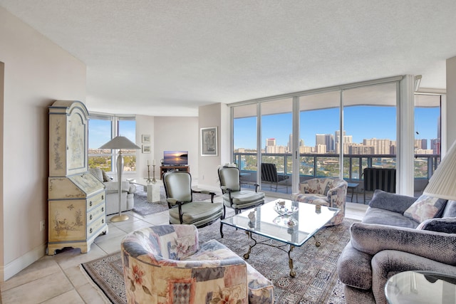 living room with light tile floors, a textured ceiling, a wealth of natural light, and a wall of windows