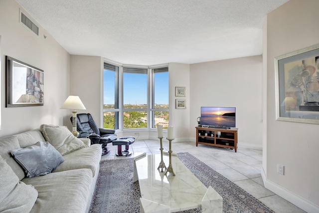 living room featuring light tile floors and a textured ceiling