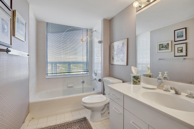 full bathroom with vanity, tile floors, toilet, and tiled shower / bath