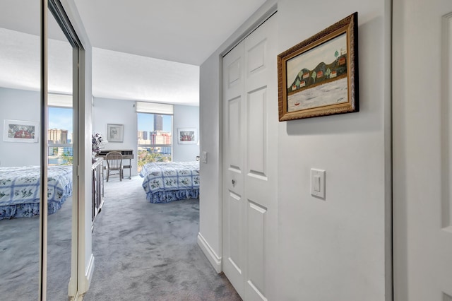 hallway with light colored carpet