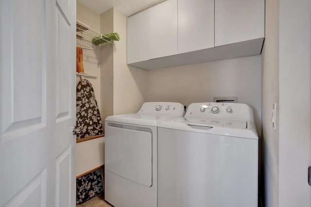 washroom featuring cabinets and separate washer and dryer