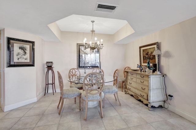 tiled dining area with a chandelier