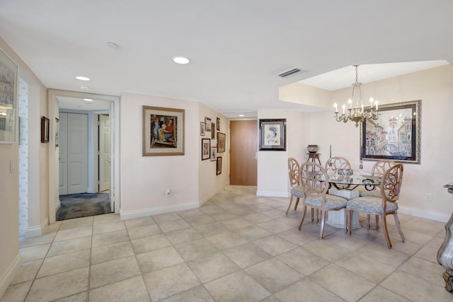 dining area with a notable chandelier and light tile floors