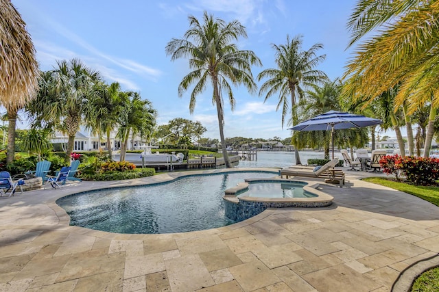 view of pool with an outdoor fire pit, a patio, an in ground hot tub, and a water view