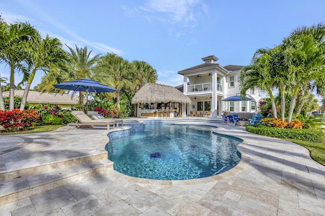 view of swimming pool featuring ceiling fan and a patio