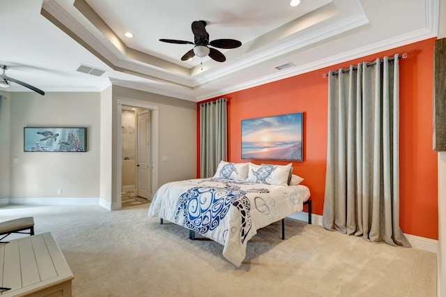 carpeted bedroom featuring ornamental molding, ceiling fan, and a tray ceiling